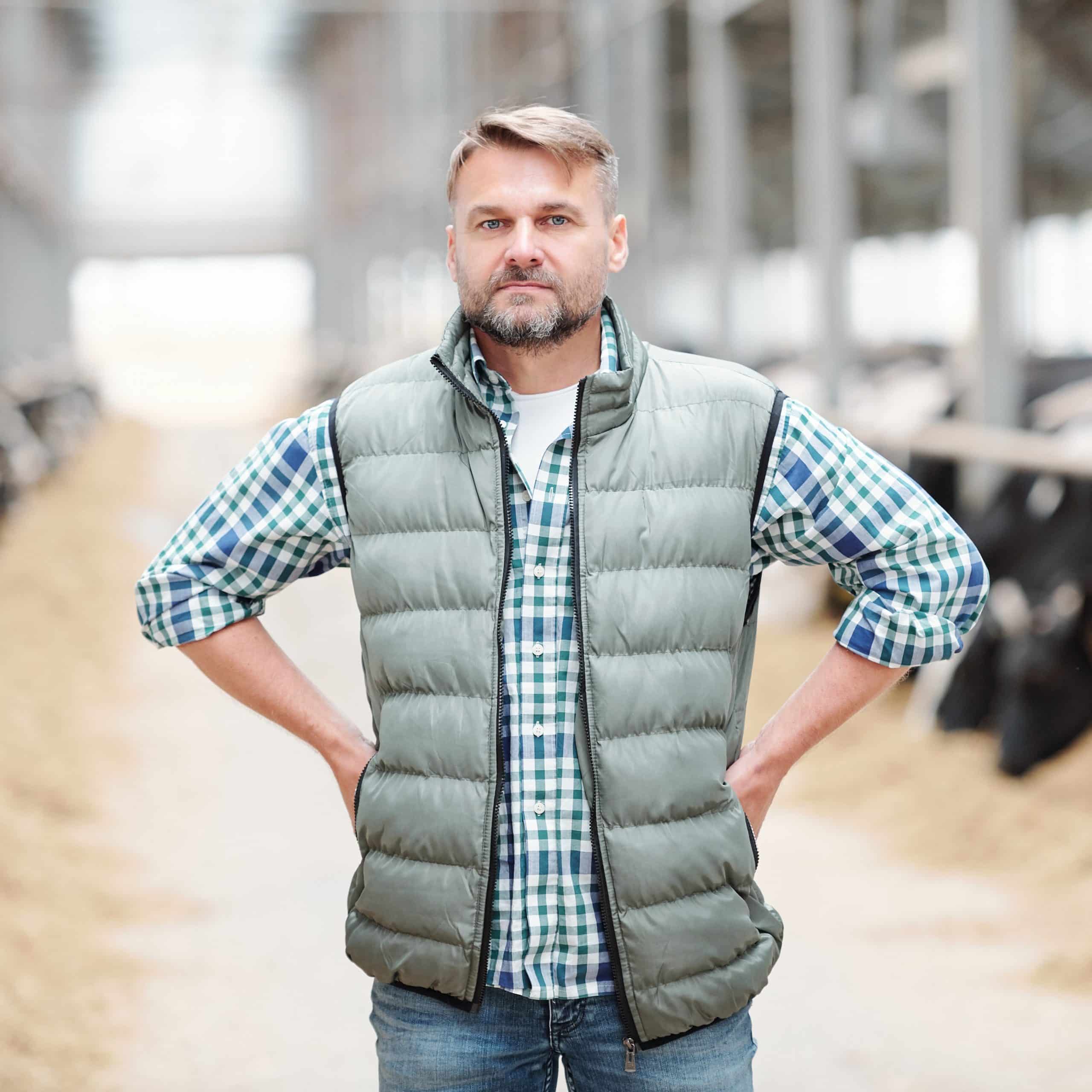 Serious mature male worker or head of contemporary dairy farm